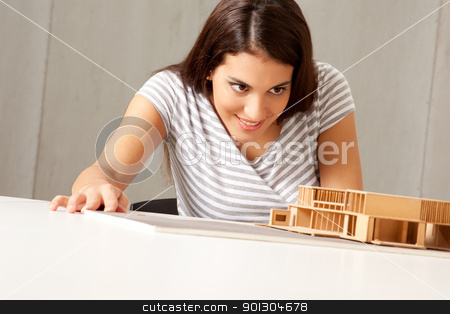 To use this stock image in your creative project, please select the size you need over to the right and click the "Add to Cart" button.
Your downloaded image will come with the Cutcaster watermark removed so don’t worry about the watermark you see on this page. Architect Examining Model stock photo, A female architect examining a rough model house by Tyler Olson