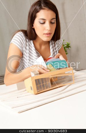 To use this stock image in your creative project, please select the size you need over to the right and click the "Add to Cart" button.
Your downloaded image will come with the Cutcaster watermark removed so don’t worry about the watermark you see on this page. Color Swatch Model House stock photo, A young architect testing color swatching on a model house by Tyler Olson