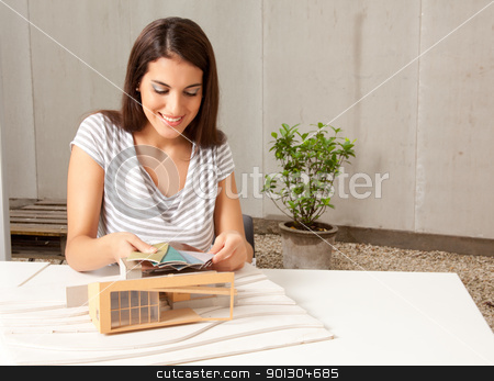 To use this stock image in your creative project, please select the size you need over to the right and click the "Add to Cart" button.
Your downloaded image will come with the Cutcaster watermark removed so don’t worry about the watermark you see on this page. Architect with Model and Color Swatches stock photo, A young female architect looking at color swatches with a model house by Tyler Olson