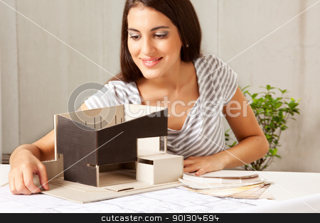 To use this stock image in your creative project, please select the size you need over to the right and click the "Add to Cart" button.
Your downloaded image will come with the Cutcaster watermark removed so don’t worry about the watermark you see on this page. Architect with Blue Prints and Model stock photo, A female architect looking over a model house with blueprints and color swatches on the table by Tyler Olson