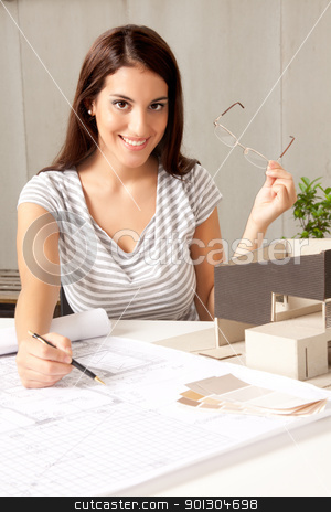 To use this stock image in your creative project, please select the size you need over to the right and click the "Add to Cart" button.
Your downloaded image will come with the Cutcaster watermark removed so don’t worry about the watermark you see on this page. Architect with Blueprints and House Model stock photo, A young female architect at a desk with blueprints and model house by Tyler Olson