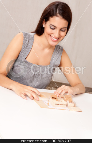 To use this stock image in your creative project, please select the size you need over to the right and click the "Add to Cart" button.
Your downloaded image will come with the Cutcaster watermark removed so don’t worry about the watermark you see on this page. Architect with House Design stock photo, A female architect designing a scale model house by Tyler Olson