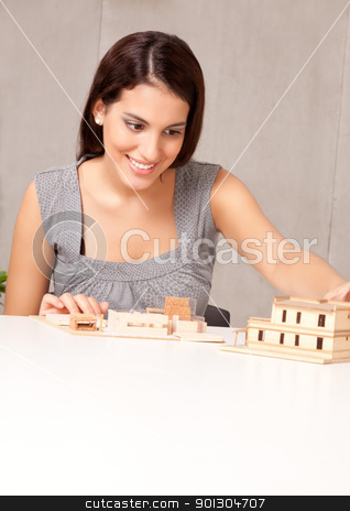 To use this stock image in your creative project, please select the size you need over to the right and click the "Add to Cart" button.
Your downloaded image will come with the Cutcaster watermark removed so don’t worry about the watermark you see on this page. Architect Design stock photo, A female architect looking at a rough building model by Tyler Olson