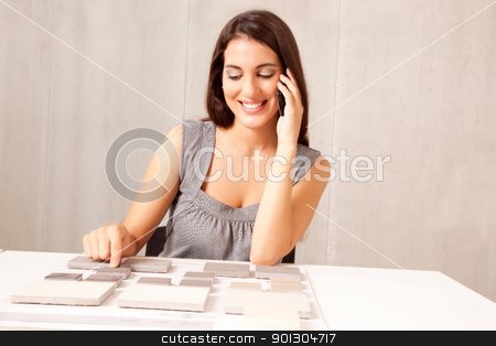 To use this stock image in your creative project, please select the size you need over to the right and click the "Add to Cart" button.
Your downloaded image will come with the Cutcaster watermark removed so don’t worry about the watermark you see on this page. Architect Design Tile stock photo, An architect / designer talking on the phone choosing a stone tile by Tyler Olson