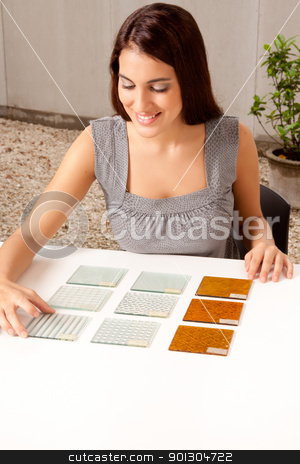 To use this stock image in your creative project, please select the size you need over to the right and click the "Add to Cart" button.
Your downloaded image will come with the Cutcaster watermark removed so don’t worry about the watermark you see on this page. Choosing Tile Sample stock photo, A female architect / designer choosing a glass tile from a group of samples by Tyler Olson
