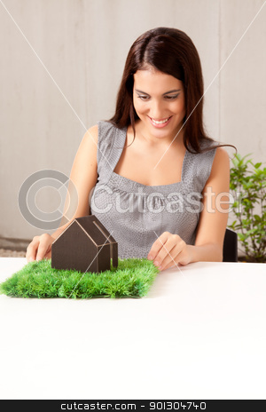 To use this stock image in your creative project, please select the size you need over to the right and click the "Add to Cart" button.
Your downloaded image will come with the Cutcaster watermark removed so don’t worry about the watermark you see on this page. Green Architecture stock photo, A happy professional woman looking at a model house with grass by Tyler Olson