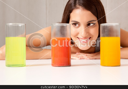 To use this stock image in your creative project, please select the size you need over to the right and click the "Add to Cart" button.
Your downloaded image will come with the Cutcaster watermark removed so don’t worry about the watermark you see on this page. Three Science Beakers with Liquid stock photo, A woman looking at three science beakers filled with colored liquid by Tyler Olson