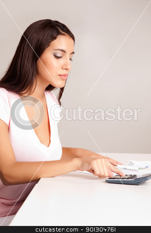 To use this stock image in your creative project, please select the size you need over to the right and click the "Add to Cart" button.
Your downloaded image will come with the Cutcaster watermark removed so don’t worry about the watermark you see on this page. Balanced Budget stock photo, A content women calculating her finances at a desk with money and a calculator by Tyler Olson