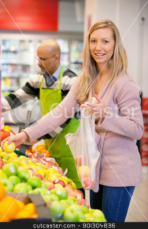 To use this stock image in your creative project, please select the size you need over to the right and click the "Add to Cart" button.
Your downloaded image will come with the Cutcaster watermark removed so don’t worry about the watermark you see on this page. Portrait of a young woman buying fruits stock photo, Portrait of a young woman buying fruits with shop assistant in the background by Tyler Olson