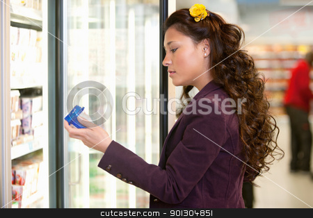 To use this stock image in your creative project, please select the size you need over to the right and click the "Add to Cart" button.
Your downloaded image will come with the Cutcaster watermark removed so don’t worry about the watermark you see on this page. Woman in Supermarket stock photo, Young woman holding container in front of refrigerator in the supermarket by Tyler Olson