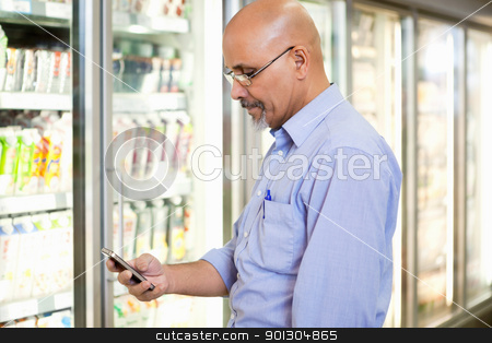 To use this stock image in your creative project, please select the size you need over to the right and click the "Add to Cart" button.
Your downloaded image will come with the Cutcaster watermark removed so don’t worry about the watermark you see on this page. Cell Phone Grocery List stock photo, Smiling mature man looking at mobile phone while standing in front of refrigerator in supermarket by Tyler Olson