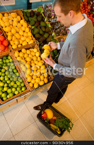 To use this stock image in your creative project, please select the size you need over to the right and click the "Add to Cart" button.
Your downloaded image will come with the Cutcaster watermark removed so don’t worry about the watermark you see on this page. Buying Lemons stock photo, A male in a grocery store buying lemons - sharp focus on lemons by Tyler Olson