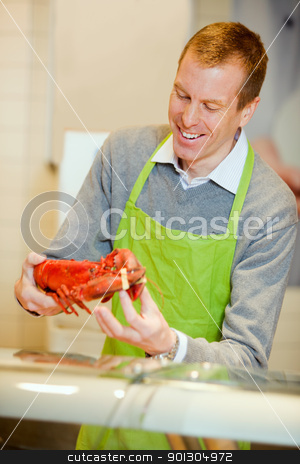 To use this stock image in your creative project, please select the size you need over to the right and click the "Add to Cart" button.
Your downloaded image will come with the Cutcaster watermark removed so don’t worry about the watermark you see on this page. Fish Counter with Lobster stock photo, A grocery store worker with a lobster at the fish counter by Tyler Olson