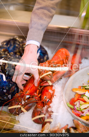 To use this stock image in your creative project, please select the size you need over to the right and click the "Add to Cart" button.
Your downloaded image will come with the Cutcaster watermark removed so don’t worry about the watermark you see on this page. Seafood Lobster stock photo, A freshly cooked lobster in a grocery store seafood display by Tyler Olson