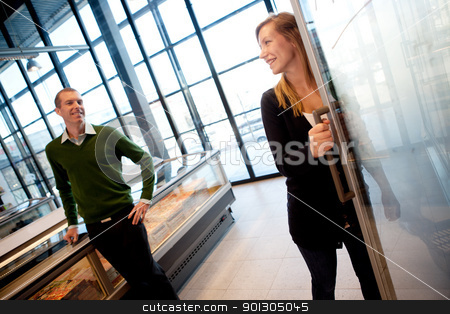 To use this stock image in your creative project, please select the size you need over to the right and click the "Add to Cart" button.
Your downloaded image will come with the Cutcaster watermark removed so don’t worry about the watermark you see on this page. Happy Couple in Supermarket stock photo, A couple smiling at eachother in a supermarket, shallow depth of field, focus on woman. by Tyler Olson