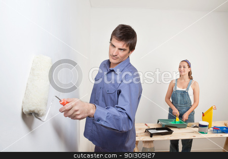 To use this stock image in your creative project, please select the size you need over to the right and click the "Add to Cart" button.
Your downloaded image will come with the Cutcaster watermark removed so don’t worry about the watermark you see on this page. Portrait of young couple painting stock photo, Serious man holding roller with woman in background by Tyler Olson