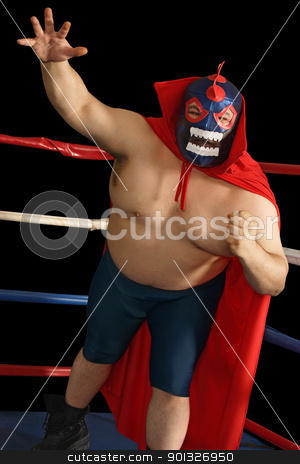 To use this stock image in your creative project, please select the size you need over to the right and click the "Add to Cart" button.
Your downloaded image will come with the Cutcaster watermark removed so don’t worry about the watermark you see on this page. Mexican wrestler attacks stock photo, Photograph of a Mexican wrestler or Luchador standing in a wrestling ring. by © Ron Sumners