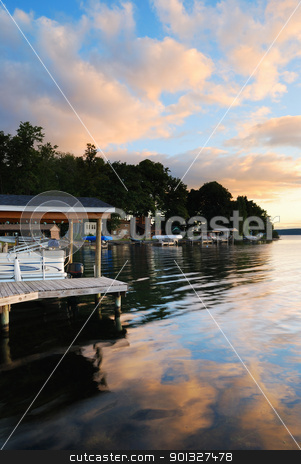 To use this stock image in your creative project, please select the size you need over to the right and click the "Add to Cart" button.
Your downloaded image will come with the Cutcaster watermark removed so don’t worry about the watermark you see on this page. Lake sunrise stock photo, Lake house with pier and woods with sunrise in the morning in New York state Finger Lakes by rabbit75_cut