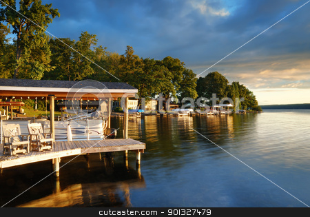 To use this stock image in your creative project, please select the size you need over to the right and click the "Add to Cart" button.
Your downloaded image will come with the Cutcaster watermark removed so don’t worry about the watermark you see on this page. Lake house stock photo, Lake house with pier and woods with sunrise in the morning in New York state Finger Lakes by rabbit75_cut
