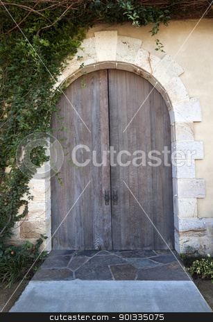 To use this stock image in your creative project, please select the size you need over to the right and click the "Add to Cart" button.
Your downloaded image will come with the Cutcaster watermark removed so don’t worry about the watermark you see on this page. Wood Doors stock photo, An old doorway with a pair of wood doors by Kevin Tietz