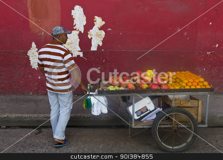 To use this stock image in your creative project, please select the size you need over to the right and click the "Add to Cart" button.
Your downloaded image will come with the Cutcaster watermark removed so don’t worry about the watermark you see on this page. Colombian fruit seller stock photo, CARTAGENA DE INDIAS , COLOMBIA - DEC 24:Unidentified colombian man sell fruits in the street in Cartagena de Indias on December 24 2010 by Kobby Dagan