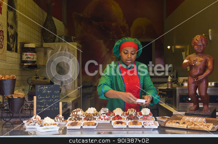 To use this stock image in your creative project, please select the size you need over to the right and click the "Add to Cart" button.
Your downloaded image will come with the Cutcaster watermark removed so don’t worry about the watermark you see on this page. Waffal seller stock photo, BRUSSELS - JULY 2 : Unidentified waffal seller in a typical waffal stand in Brussels Belgium on July 2 2011. by Kobby Dagan