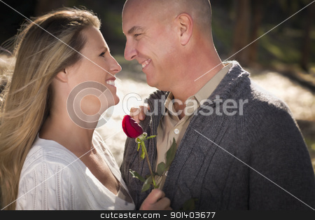 To use this stock image in your creative project, please select the size you need over to the right and click the "Add to Cart" button.
Your downloaded image will come with the Cutcaster watermark removed so don’t worry about the watermark you see on this page. Attractive Young Couple with Rose stock photo, Attractive Young Couple Wearing Sweaters with a Rose in the Park. by Andy Dean