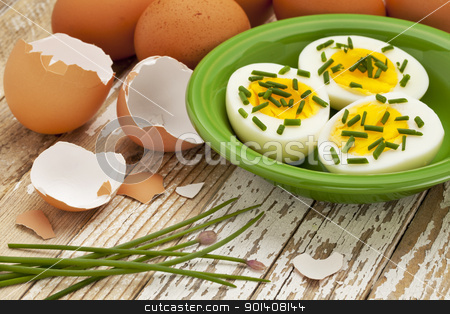 To use this stock image in your creative project, please select the size you need over to the right and click the "Add to Cart" button.
Your downloaded image will come with the Cutcaster watermark removed so don’t worry about the watermark you see on this page. spring or Easter egg concept stock photo, boiled chicken eggs with green chive against grunge wood surface - Easter or spring concept by Marek Uliasz