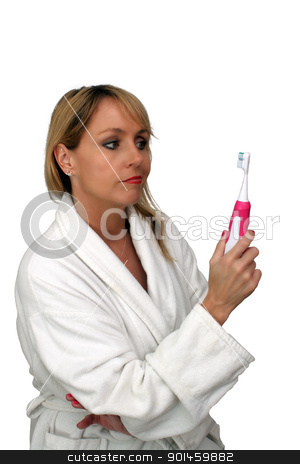 To use this stock image in your creative project, please select the size you need over to the right and click the "Add to Cart" button.
Your downloaded image will come with the Cutcaster watermark removed so don’t worry about the watermark you see on this page. Beautiful Blonde Looks Doubtfully at Toothbrush stock photo, A lovely blonde looks doubtfully at her electric toothbrush. Isolated on a white background. by Carl Stewart