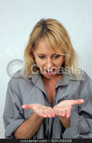 To use this stock image in your creative project, please select the size you need over to the right and click the "Add to Cart" button.
Your downloaded image will come with the Cutcaster watermark removed so don’t worry about the watermark you see on this page. Beautiful Blonde Looks Surprisingly at Her Hands stock photo, A lovely blonde looks surprisingly and excitedly at her extended hands. Perfect for inserting your product or graphic. by Carl Stewart