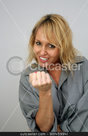 To use this stock image in your creative project, please select the size you need over to the right and click the "Add to Cart" button.
Your downloaded image will come with the Cutcaster watermark removed so don’t worry about the watermark you see on this page. Beautiful Blonde Playfully Raises Her Fist stock photo, A lovely blonde with a captivating smile raises her fist to play-fight. by Carl Stewart