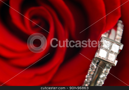 To use this stock image in your creative project, please select the size you need over to the right and click the "Add to Cart" button.
Your downloaded image will come with the Cutcaster watermark removed so don’t worry about the watermark you see on this page. Macro Engagement Ring stock photo, A macro view of a diamond engagement ring, resting in a red rose. by Richard Nelson