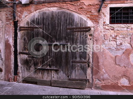 To use this stock image in your creative project, please select the size you need over to the right and click the "Add to Cart" button.
Your downloaded image will come with the Cutcaster watermark removed so don’t worry about the watermark you see on this page. Very Old Large Wooden Door stock photo, A very old large wooden double door with a large lock. by Chris Hill
