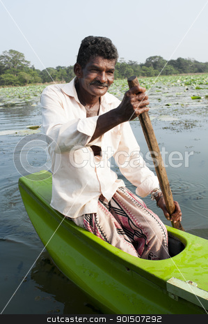 To use this stock image in your creative project, please select the size you need over to the right and click the "Add to Cart" button.
Your downloaded image will come with the Cutcaster watermark removed so don’t worry about the watermark you see on this page. Smiling Asian man row a small traditional boat stock photo, Habarane, Sri Lanka - December 04, 2011: Smiling Sri Lankian man are floating by small traditional green boat upon a lake. by Iryna Rasko