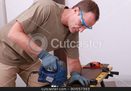 To use this stock image in your creative project, please select the size you need over to the right and click the "Add to Cart" button.
Your downloaded image will come with the Cutcaster watermark removed so don’t worry about the watermark you see on this page. Man using an electric saw to cut a wooden floorboard stock photo, Man using an electric saw to cut a wooden floorboard by photography33