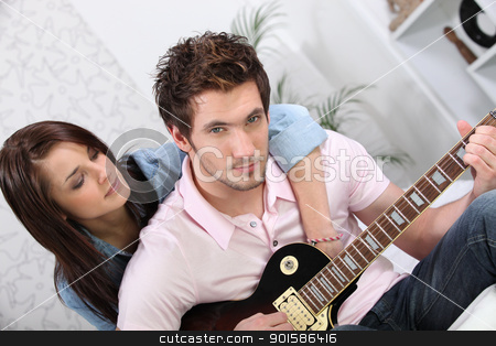 To use this stock image in your creative project, please select the size you need over to the right and click the "Add to Cart" button.
Your downloaded image will come with the Cutcaster watermark removed so don’t worry about the watermark you see on this page. Woman hugging her boyfriend while he plays the guitar stock photo, Woman hugging her boyfriend while he plays the guitar by photography33