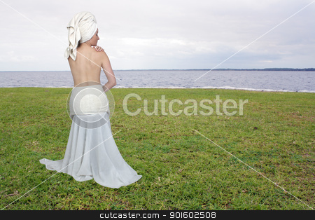 To use this stock image in your creative project, please select the size you need over to the right and click the "Add to Cart" button.
Your downloaded image will come with the Cutcaster watermark removed so don’t worry about the watermark you see on this page. Beautiful Bath-n-Body Woman (7) stock photo, A lovely woman wearing bath towels, topless facing away from the camera. Sitting on a peaceful, grassy lakeshore. Generous copyspace. by Carl Stewart