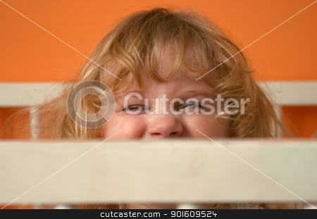 To use this stock image in your creative project, please select the size you need over to the right and click the "Add to Cart" button.
Your downloaded image will come with the Cutcaster watermark removed so don’t worry about the watermark you see on this page. Girl face expression stock photo, Small girl with funny face expression behind fence of bed by vaximilian