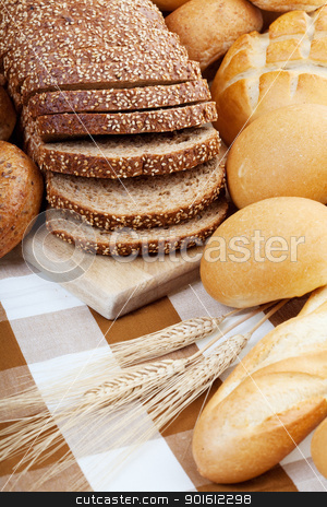 To use this stock image in your creative project, please select the size you need over to the right and click the "Add to Cart" button.
Your downloaded image will come with the Cutcaster watermark removed so don’t worry about the watermark you see on this page. Bread assortment stock photo, Assortment of baked bread with focus on the sliced loaf. by Steve Mcsweeny