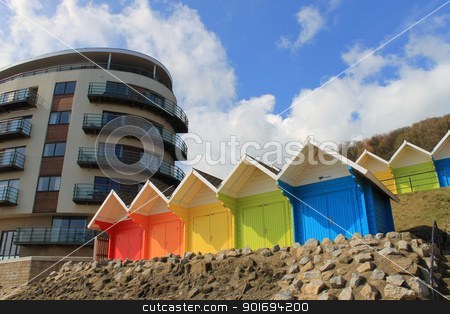 To use this stock image in your creative project, please select the size you need over to the right and click the "Add to Cart" button.
Your downloaded image will come with the Cutcaster watermark removed so don’t worry about the watermark you see on this page. Beach chalets and tourst hotel stock photo, Beach chalets and tourist hotel building with blue sky and cloudscape background. by Martin Crowdy