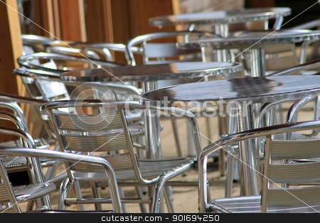 To use this stock image in your creative project, please select the size you need over to the right and click the "Add to Cart" button.
Your downloaded image will come with the Cutcaster watermark removed so don’t worry about the watermark you see on this page. Vacant metal chairs and tables stock photo, Vacant metal chairs and tables on outdoor eating area in cafe or restaurant. by Martin Crowdy