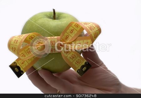 To use this stock image in your creative project, please select the size you need over to the right and click the "Add to Cart" button.
Your downloaded image will come with the Cutcaster watermark removed so don’t worry about the watermark you see on this page. Symbol of diet and healthy eating. stock photo, Green apple with measuring tape in a hand. by Yury Ponomarev