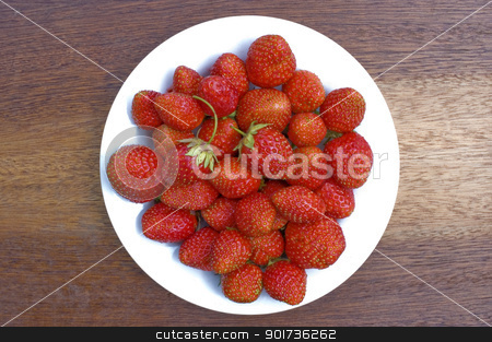 To use this stock image in your creative project, please select the size you need over to the right and click the "Add to Cart" button.
Your downloaded image will come with the Cutcaster watermark removed so don’t worry about the watermark you see on this page. Strawberry. stock photo, Red, ripe wild strawberry in a white plate on a brown background. by Yury Ponomarev