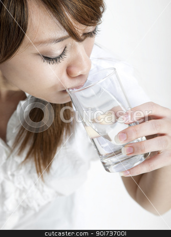 To use this stock image in your creative project, please select the size you need over to the right and click the "Add to Cart" button.
Your downloaded image will come with the Cutcaster watermark removed so don’t worry about the watermark you see on this page. Drinking Water stock photo, Young girl drinking a glass of mineral water by szefei