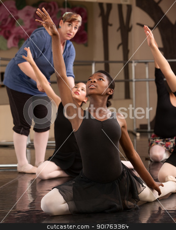 To use this stock image in your creative project, please select the size you need over to the right and click the "Add to Cart" button.
Your downloaded image will come with the Cutcaster watermark removed so don’t worry about the watermark you see on this page. Kneeling Dance Students stock photo, Ballet class teacher helps students practice dance moves by Scott Griessel