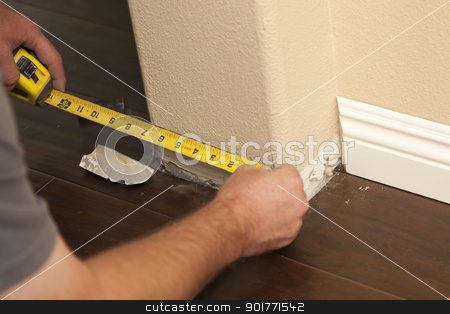 To use this stock image in your creative project, please select the size you need over to the right and click the "Add to Cart" button.
Your downloaded image will come with the Cutcaster watermark removed so don’t worry about the watermark you see on this page. Measuring for New Baseboard with Bull Nose Corners and New Lamin stock photo, Contractor Measuring for New Baseboard with Bull Nose Corners and New Laminate Flooring Abstract. by Andy Dean
