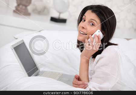 To use this stock image in your creative project, please select the size you need over to the right and click the "Add to Cart" button.
Your downloaded image will come with the Cutcaster watermark removed so don’t worry about the watermark you see on this page. Woman using a phone and laptop in her bedroom stock photo, Woman using a phone and laptop in her bedroom by photography33