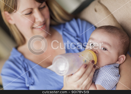 To use this stock image in your creative project, please select the size you need over to the right and click the "Add to Cart" button.
Your downloaded image will come with the Cutcaster watermark removed so don’t worry about the watermark you see on this page. Happy Mother Bottle Feeding Her Son stock photo, Happy Mother Bottle Feeding Her Very Content Son. by Andy Dean