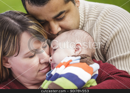 To use this stock image in your creative project, please select the size you need over to the right and click the "Add to Cart" button.
Your downloaded image will come with the Cutcaster watermark removed so don’t worry about the watermark you see on this page. Happy Mixed Race Parents Hugging Their Son stock photo, Happy Mixed Race Parents Hugging Their Son in the Park. by Andy Dean