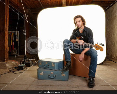To use this stock image in your creative project, please select the size you need over to the right and click the "Add to Cart" button.
Your downloaded image will come with the Cutcaster watermark removed so don’t worry about the watermark you see on this page. Musician With Guitar in Studio stock photo, Young musician with guitar in photography studio by Scott Griessel